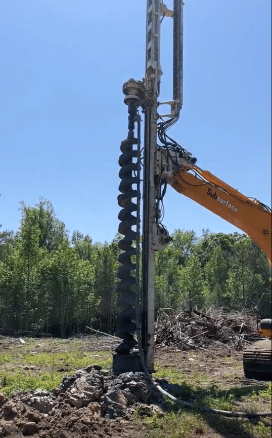 A photo of a foundation rig drilling an auger cast pile.